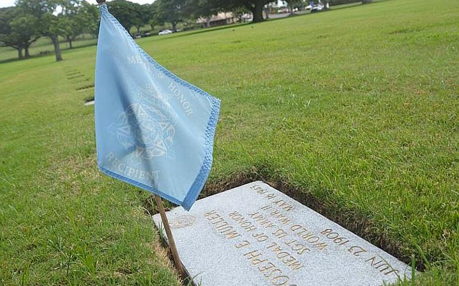 A blue flag that flies next to the grave of World War II veteran Joseph Muller identifies him as a Medal of Honor recipient, one of 32 buried and 30 more memorialized at the National Cemetery of the Pacific in Honolulu. On Oct. 3, 2012, 52 of the nation's 81 living Medal of Honor recipients dedicated a stone memorial to the fallen recipients of the nation's highest military honor.