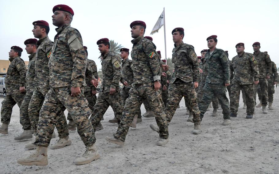 Troops with the Iraqi army's 1st Battalion, 56th Baghdad Brigade march in their compound in Baghdad's Green Zone. The unit is responsible for security in the zone.