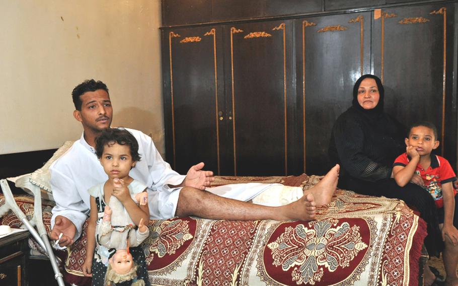 Fadel Nathem was the equivalent of a specialist when he was wounded by a suicide car bomber in September 2008. With him in the room where he lives is Mariam, his 4-year-old daughter, Yasra Abd Ali, his mother and main caretaker, and his youngest brother.