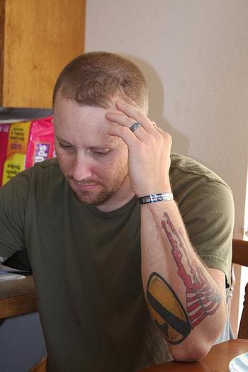 Lisek pauses as he speaks about his problems dealing with the Army and VA through his rehabilitation process for injuries he received in Iraq. On his wrist is bracelet bearing the name of Spc. Chris White, the son of a friend who was killed in Iraq.