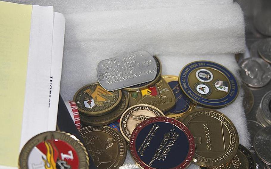 Lisek's dog tags sit in a safety deposit box among military coins and other mementos he has collected since his September 2004 injury.