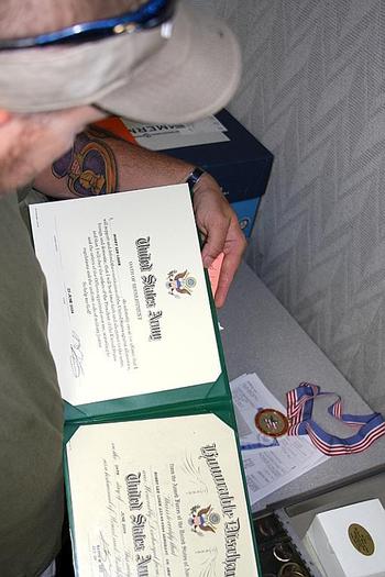 Lisek looks over the Army re-enlistment orders he signed a few months before getting injured in Iraq in September 2004. He now stores the papers in a safe deposit box with other mementos from his time in the service.