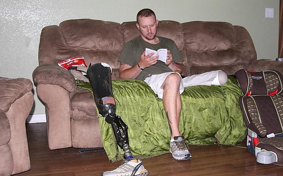 Lisek relaxes in his family room while trying to assemble a car seat for his daughter, Gracie.