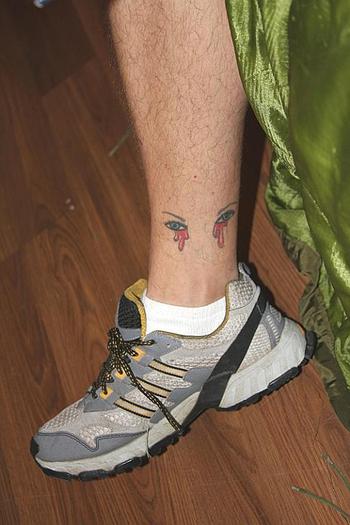 Among Lisek's many tattoos are two eyes crying blood on his right ankle, staring at where his left leg should be.