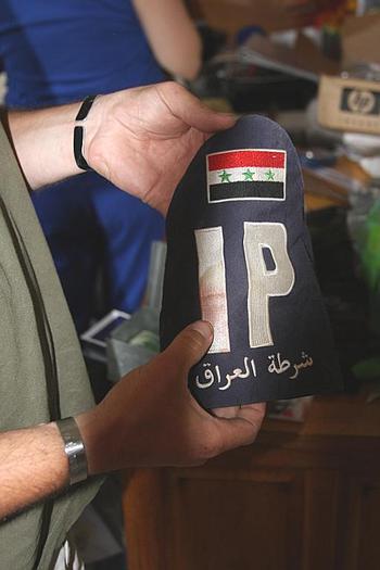 Lisek holds part of an Iraqi police uniform he took from a firefight in summer 2004. He said he's not sure if the blood belonged to the policeman or the insurgent he was fighting.