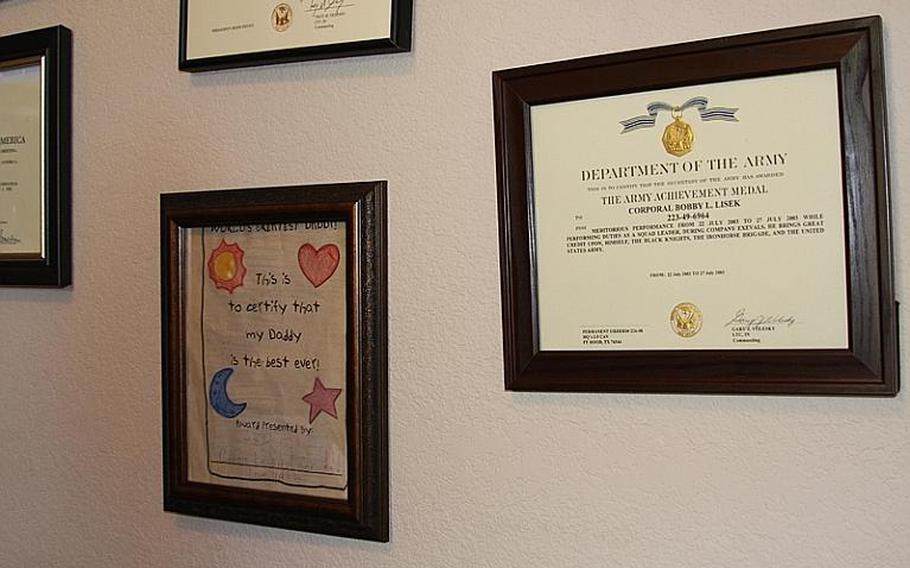 A note from Lisek's daughter hangs among award citations from the Army.