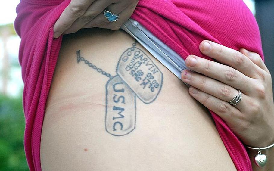The day her husband was cremated, Melissa had an image of his dogtags tattooed on her torso.