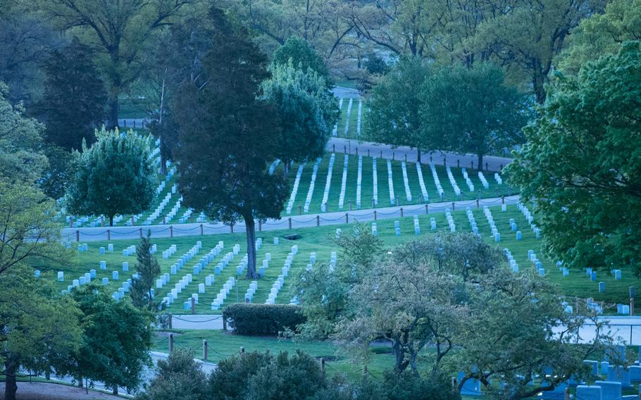 Arlington National Cemetery is just starting to come out of the shadows in the early morning of May 4, 2014.