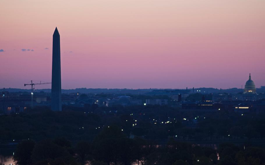 The Washington Monument and the Capitol Building are silhouetted against the early morning sky on May 4, 2014. 