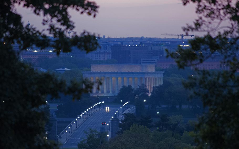 The Lincoln Memorial, still lit up for the night, is bathed in pinks in the early morning hours of May 4, 2014.