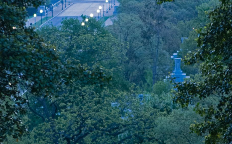 The Lincoln Memorial and Arlington National Cemetery is seen through the trees in the early morning hours of May 4, 2014. 