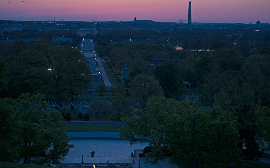 Washington, D.C., is just waking up as the sunrises over the city and Arlington National Cemetery on May 4, 2014. Seen in this photo is President John F. Kennedy's eternal flame, the Lincoln Memorial in a straight line from it, the Washington Monument and the Capitol Building to the far right. 
