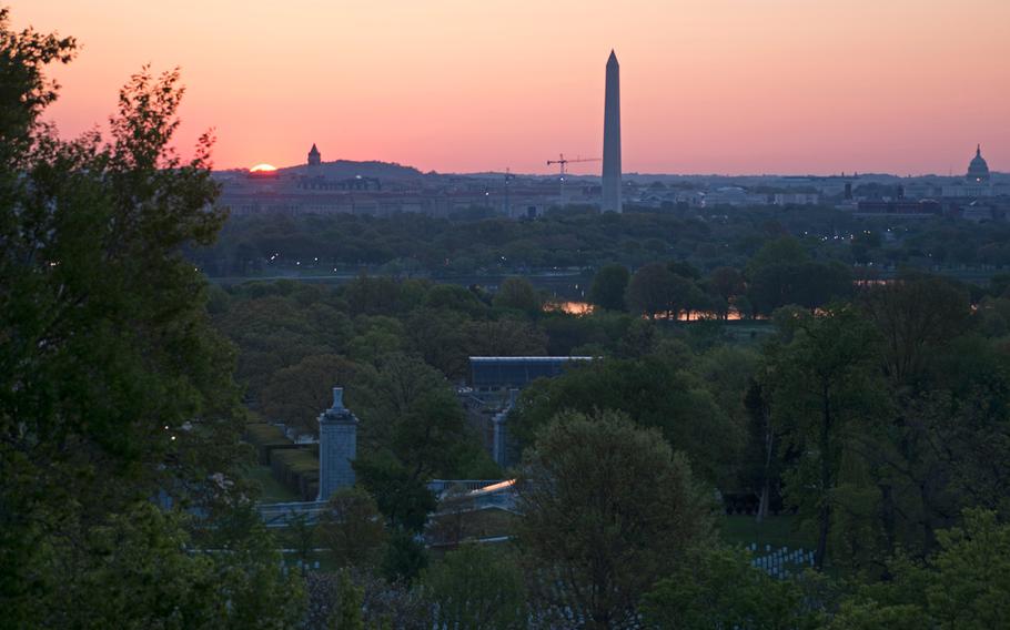 Arlington National Cemetery is seen as the sun starts to rise over Washington, D.C., on May 4, 2014.