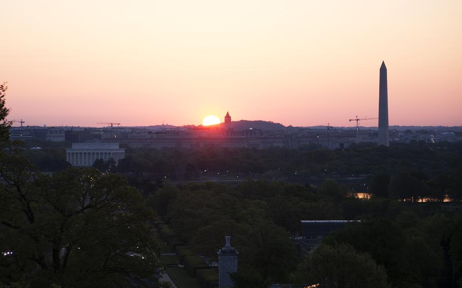 The sun starts to peak over the Washington, D.C., skyline on May 4, 2014.