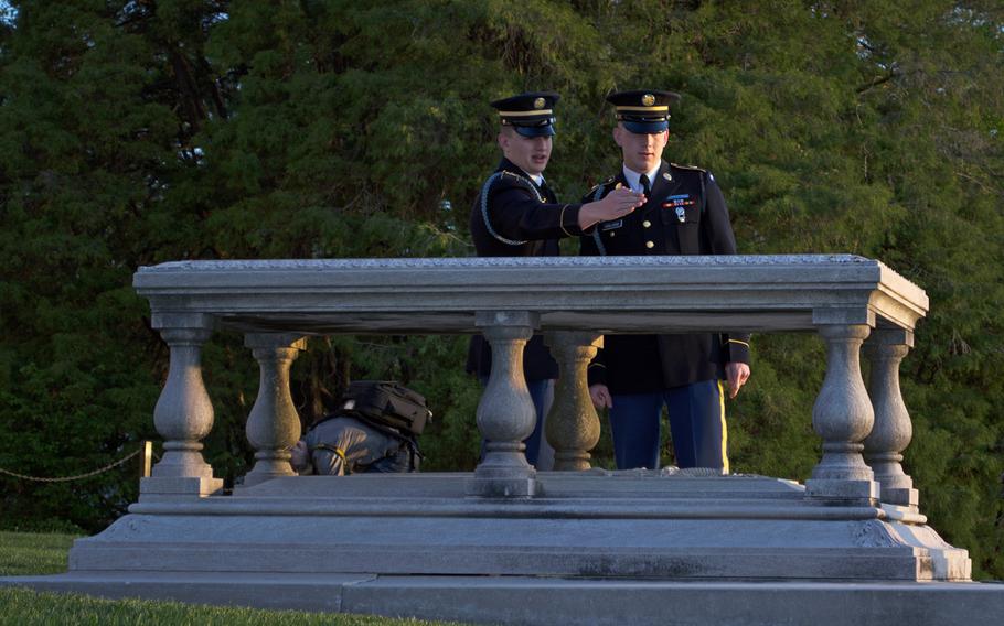 Spc. Erik Holland, right, and Pfc. William Martin discuss a grave marker in front of the Arlington House at Arlington National Cemetery on May 4, 2014, at 6:30 in the morning. 