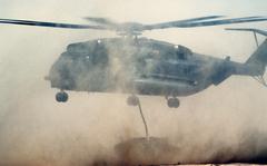 A Marine CH-53 Sea Stallion helicopter lowers an M998 High-Mobility Multipurpose Wheeled Vehicle (HMMWV) to the ground during Exercise Imminent Thunder, part of Operation Desert Shield.