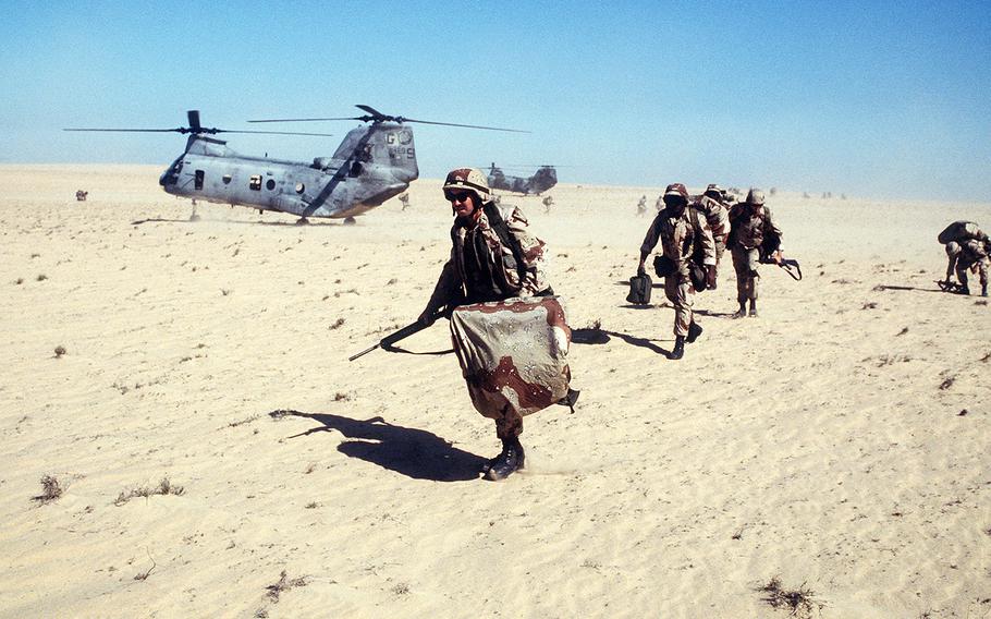 Marines of Co. C, 1st Bn., 2nd Marine Div.,  move out on a mission after disembarking from a Marine Medium Helicopter Squadron 263 (HMM-263) CH-46E Sea Knight helicopter during   Exercise Imminent Thunder, part of Operation Desert Shield.  
