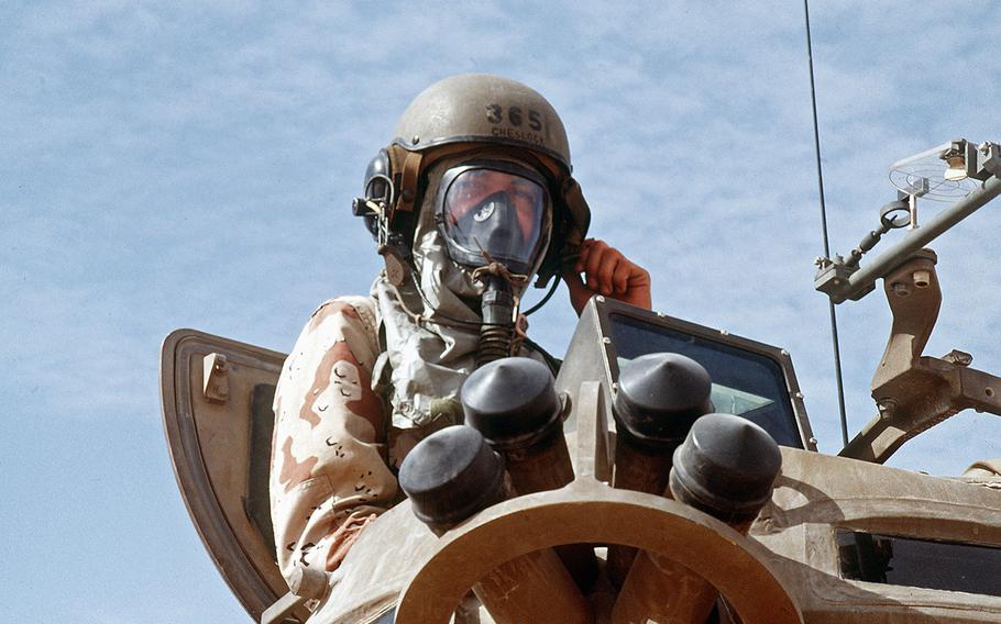 A U.S. Marine armored vehicle crewman wears a nuclear-biological-chemical protective mask while taking part in NBC training during Operation Desert Shield. DoD photo
