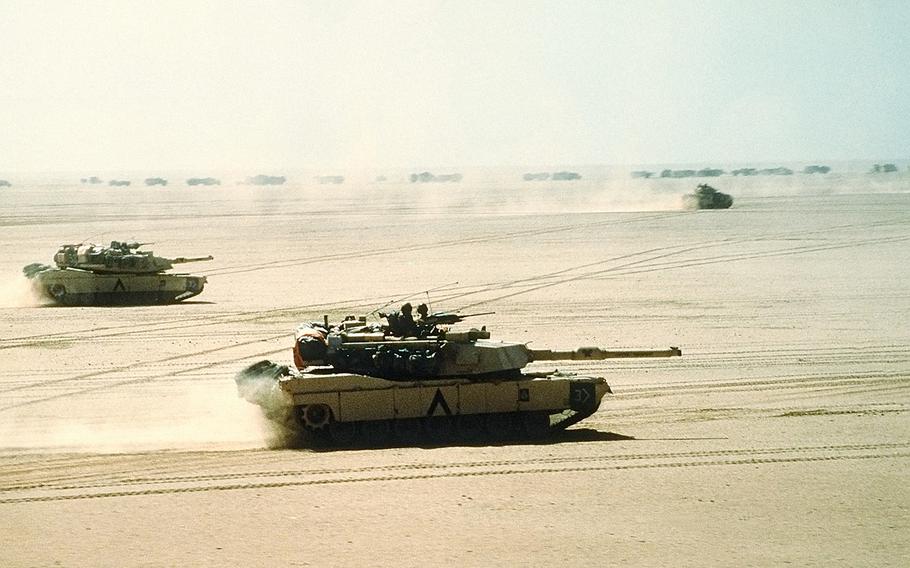M1A1 Abrams main battle tanks of the 3rd Armored Division move out on a mission during Operation Desert Storm, Feb. 15, 1991. An M2/M3 Bradley can be seen in background.