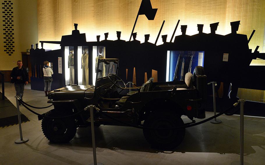 A jeep, uniforms and weapons are displayed in the former Outpost Theater that today makes up a section of the Allied Museum in Berlin. The museum is in two buildings and an open-air site that was once part of the American garrison in Berlin.