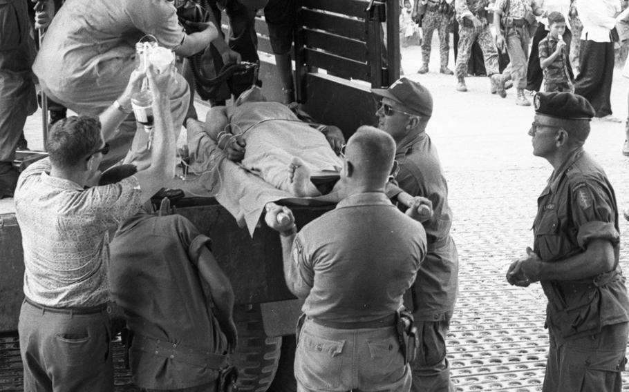 A badly-wounded U.S. Special Forces sergeant is moved from a small field hospital to Saigon in 1965.