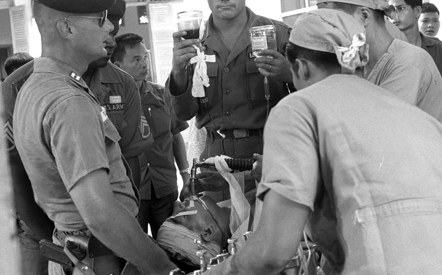 A U.S. Special Forces sergeant gets medical attention at a small field hospital in Vietnam in 1965. The soldier had been shot in the head while delivering medical supplies to a remote Vietnamese village.