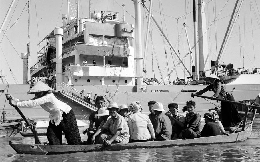 December, 1965: The passengers in this small boat crossing Saigon Harbor probably wished they could enjoy he roominess of the larger (and safer) craft in the background.