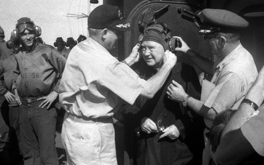 December, 1965: Francis Cardinal Spellman is fitted with appropriate headgear as he tours the deck of the USS Ticonderoga, off the coast of Vietnam, after arriving from Tan Son Nhut Air Base. Spellman, the Archbishop of New York and Apostolic Vicar for the U.S. Armed Forces, celebrated Mass in the ship's hangar bay, ate in the enlisted men's mess, and visited patients in sick bay during his visit.