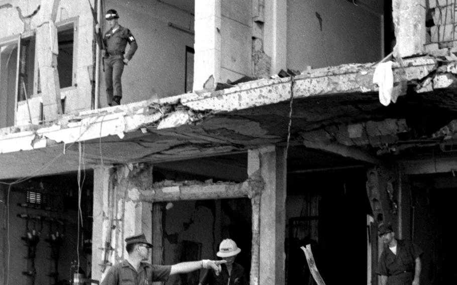 December, 1965: An MP stands guard on the devastated second floor of Saigon's Metropole Hotel as rescue efforts continue five hours after a truck bomb exploded outside the building, which served as a bachelor enlisted men's quarters for the U.S. military. Eight Vietnamese, one U.S. Marine and a soldier from New Zealand were killed in the early-morning blast that also injured more than 175 people, including 72 Americans.