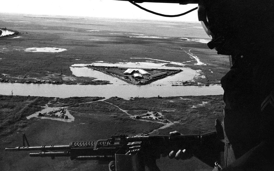 November, 1965: A crew member mans a machine gun in a helicopter circling a Special Forces camp in South Vietnam's Mekong Delta area. Copters brought soldiers and supplies to remote outposts from Vinh Long airfield, home of the U.S. Army's 502nd and 114th Aviation Battalions.