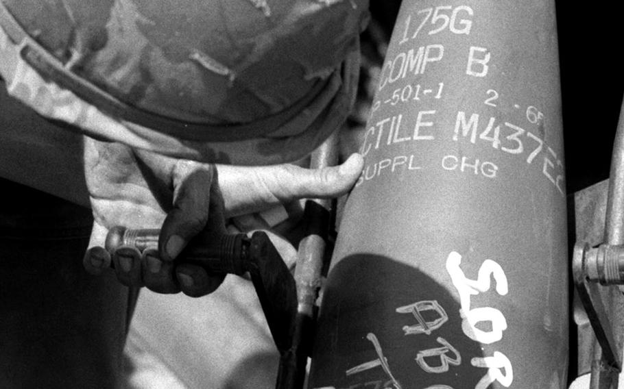 November, 1965: Brig. Gen. Charles M. Mount, assistant commanding officer of the 1st Infantry Division, scrawls a message for the Viet Cong on a shell that's about to be fired by one of the new 175-mm guns being used in Vietnam for the first time. The gun, one of several belonging to the 2nd Battalion, 32nd Artillery Brigade, 23rd Field Artillery Group, could fire a shell about 20 miles.