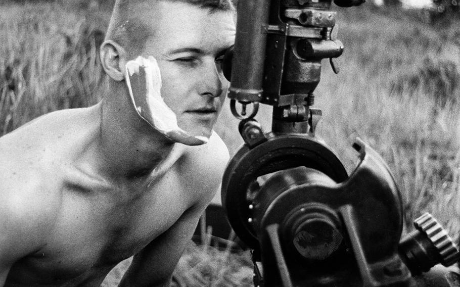 July, 1965: A fire mission caught Sgt. Homer Charnock of Bravo Battery, 319th Artillery, in the middle of shaving, so he dropped his razor and rushed into position to man his gunsight.