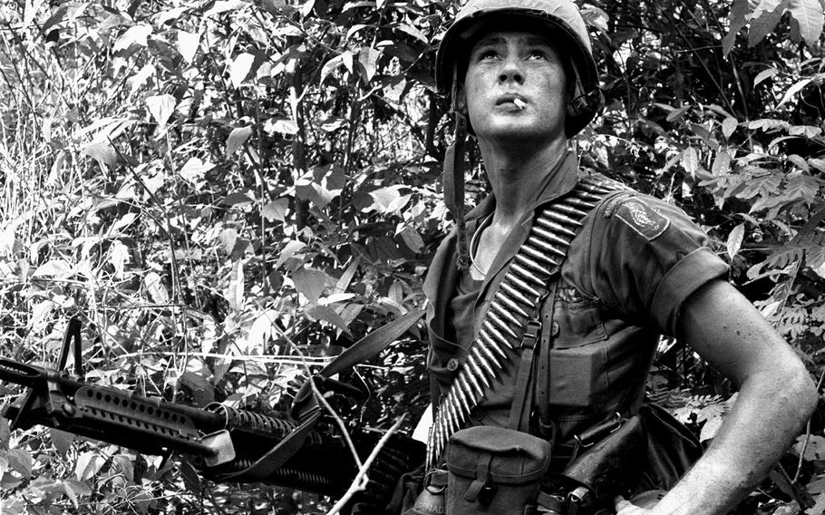 May, 1965: A soldier from the 173rd Airborne Brigade scans a clearing for signs of trouble during a jungle patrol out of Binh Hoa.