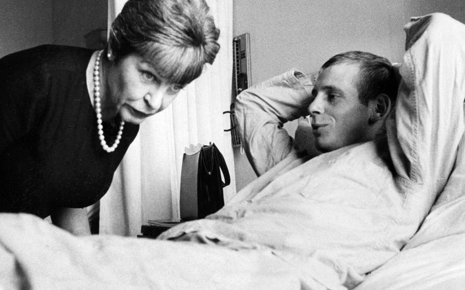 May, 1965: Comedian Martha Raye, in the Philippines on a USO tour, visits with Sgt. Richard Bartlett at the Clark Air Base Hospital. Bartlett, of Det. B, 1st Special Forces Group, suffered leg and neck wounds and lost his hearing in the battle at Song Be, South Vietnam. During the fighting, he played dead as he was stepped on and kicked by Viet Cong soldiers, one of whom used Bartlett's body to steady his rifle.
