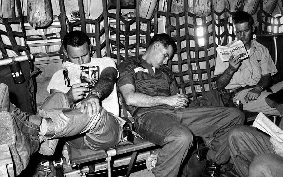 January, 1965: Passengers on this Marine flight from the Philippines to Vietnam didn't have to worry about returning their seats to an upright position before landing, but they did need to find ways to fight off boredom.