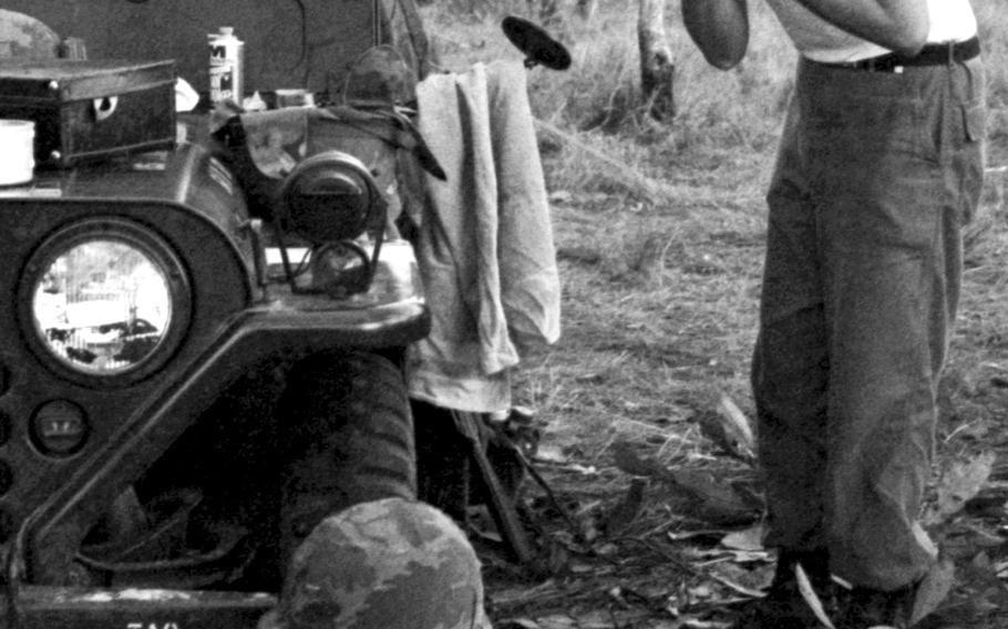 Lt. Col. Frederick Ackerson, 1st Battalion, 5th Cavalry, 1st Cavalry Division commander, shaves in front of a jeep's mirror near Plei Me, Vietnam, in November, 1965.