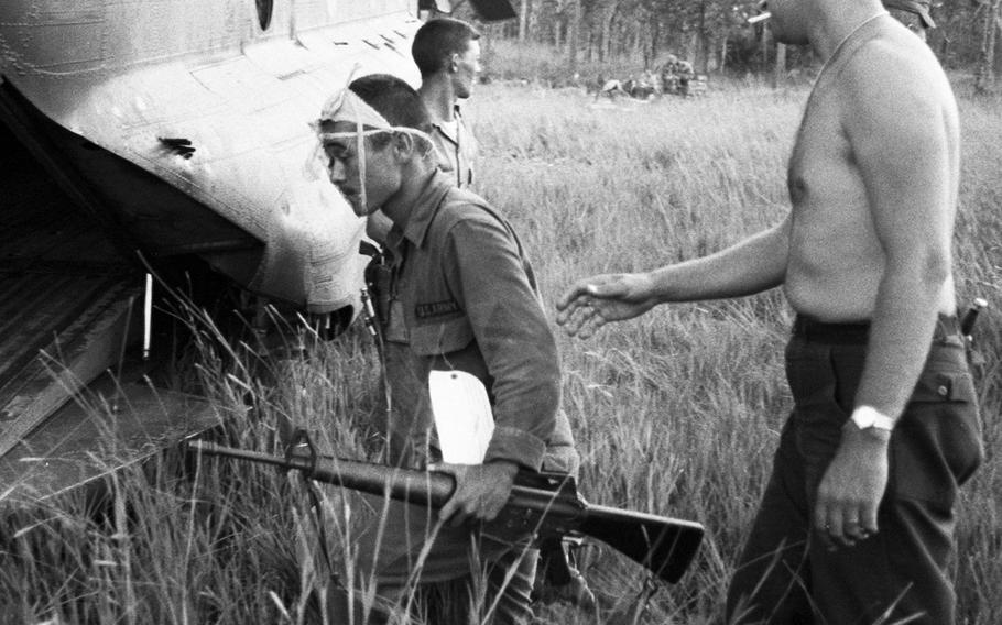 A soldier wounded in fighting near Plei Me, Vietnam, is helped to a waiting helicopter for a flight to Pleiku in November, 1965.