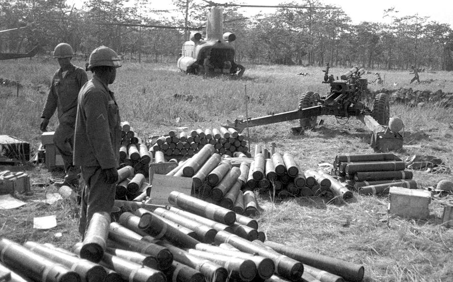 Soldiers from an artillery battalion unpack howitzer shells brought in to a landing zone near Plei Me, Vietnam, in November, 1965.