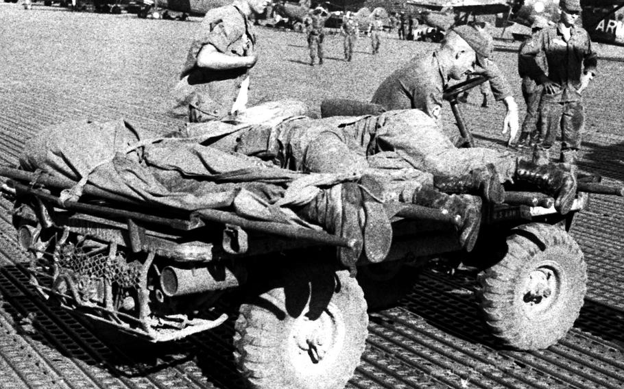 The bodies of soldiers killed in fighting near Plei Me, Vietnam, arrive at Pleiku in November, 1965.