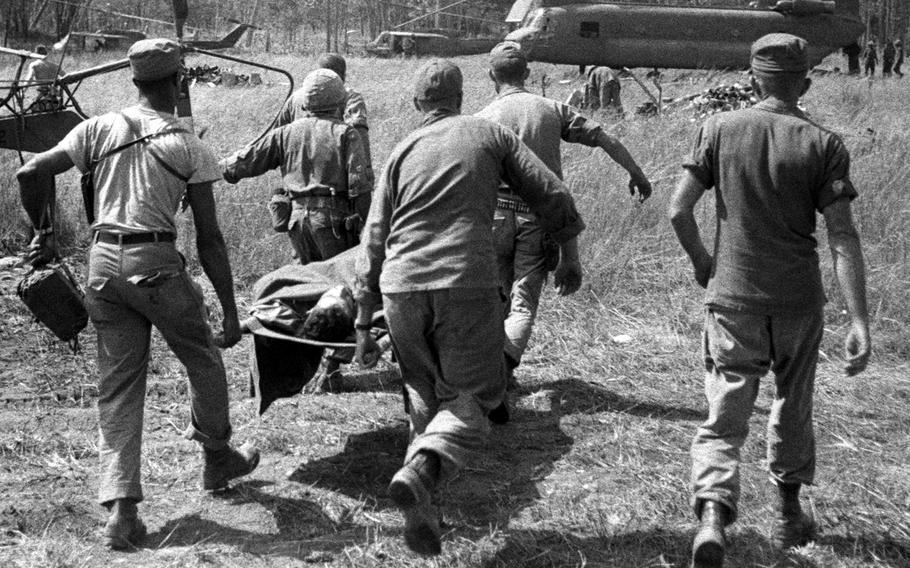 A soldier wounded in fighting near Plei Me, Vietnam, is carried to a waiting helicopter for a flight to Pleiku in November, 1965.