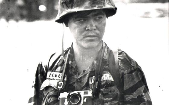 This undated photo shows Associated Press photojournalist Nick Ut in South Vietnam. Minutes after a South Vietnamese plane accidentally dropped napalm on its own troops and civilians in Trang Bang village on June 8, 1972, Ut made the iconic photograph of 9-year-old Kim Phuc running naked and crying on a road leading away from the village. Ut remembers the girl screaming in Vietnamese, "Too hot! Too hot!" He took her to a hospital and she survived against incredible odds. (AP Photo)