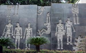 A stone mural memorializes inmates who were tortured and killed at the former Hoa Lo prison, otherwise known as the Hanoi Hilton, which held Vietnamese revolutionaries and later American prisoners of war. 