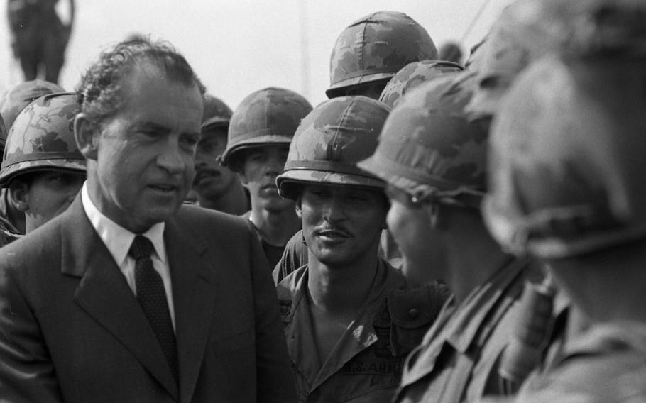 President Richard Nixon chats and shakes hands with the men at the 1st Infantry Division's Di An base camp in South Vietnam on July 30, 1969. 