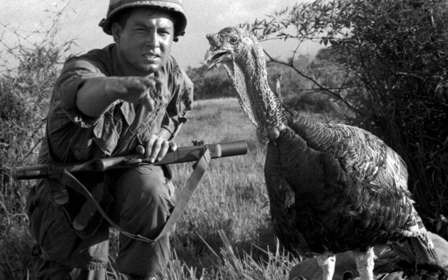 Spec. 4 Fred Gutierrez makes the grab for the mess hall table at the 9th Inf. Div.'s Bear Cat base camp.