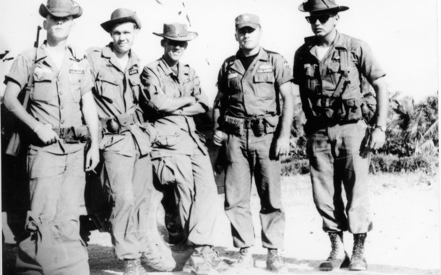 As described by Austin Miller: "From left to right: SSgt Blaine, Sp4 Cornwell, Capt Miller, SSgt Ketron, 1/Lt Kiger, Long Hoa Village, Long An Province Jan 1965"