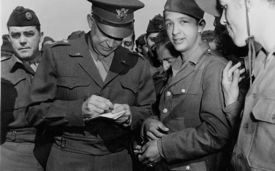 Staff Sgt. Charles Kiley, left, was assigned by his Stars and Stripes editors to cover General Dwight d. Eisenhower near the end of World War II. In this April 1945 photo, Eisenhower meets repatriated Allied prisoners of war in France.