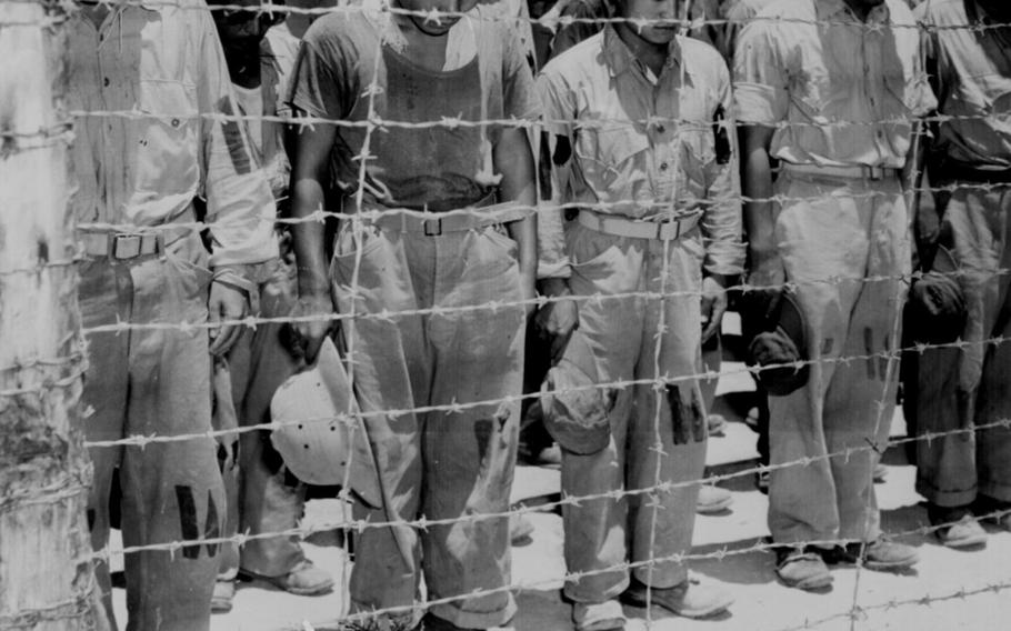 Japanese prisoners of war in Guam bow their heads on Aug. 15, 1945, after hearing that Emperor Hirohito has agreed to Japan's unconditional surrender.