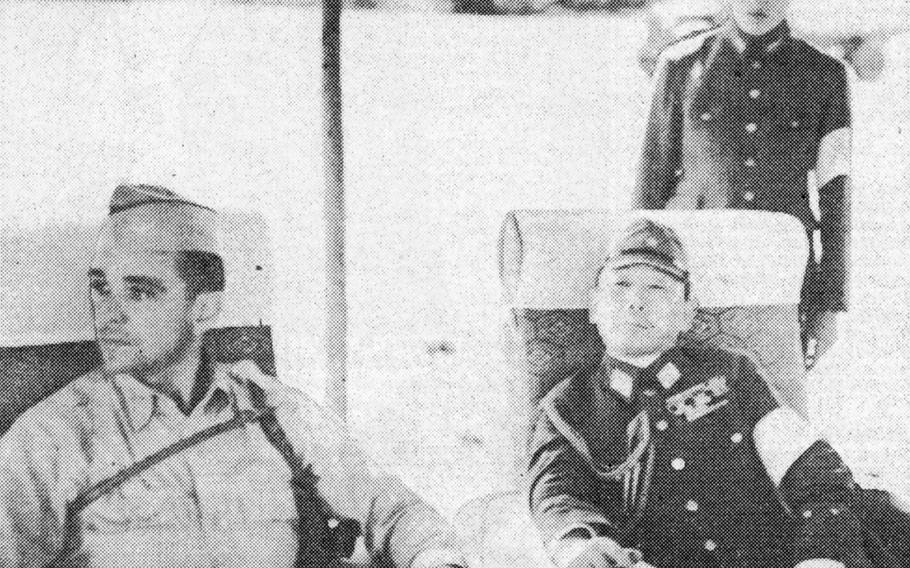 Col. C. H. Tench, left, of General Headquarters for the Supreme Allied Command, confers with Lt. Gen. Seizo Arisuyu after the landing at Atsugi airfield near Tokyo by Americ an Army and Navy representatives.