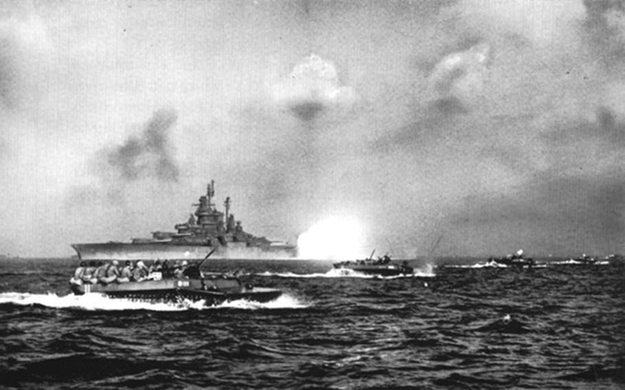 The USS Tennessee bombards the Okinawa shoreline as Navy gunboats make their way to the island. The main U.S. landing took place on April 1, 1945 on the western side of the island.