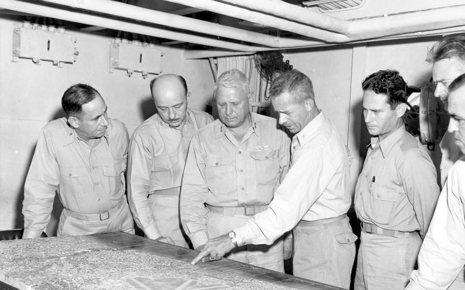 Brig. Gen. Merwin H. Silverthorn, 3rd Amphibious Corps chief of staff, center, designates on a relief map a Japanese position on an Okinawa beach prior to the invasion. 
